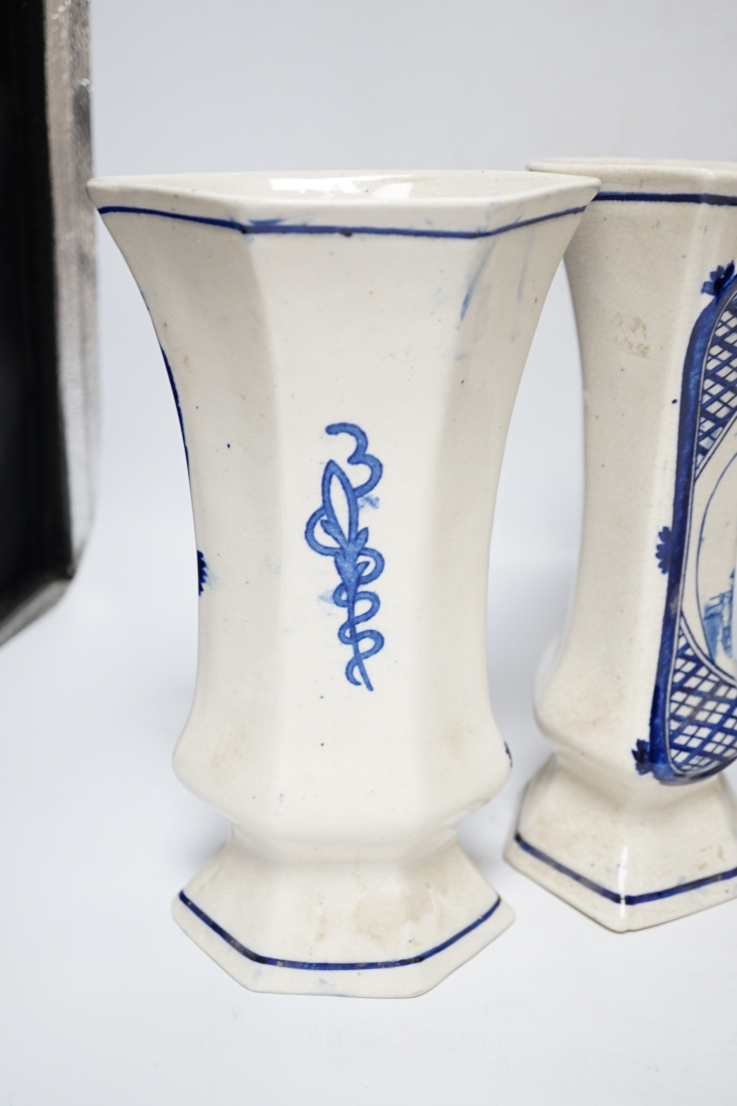 A trio of cream and blue glazed pottery vases, one with cover, tallest 34cm high